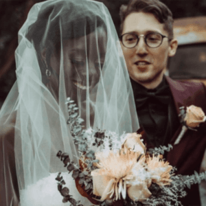 Mr. and Mrs. Anderson, the bride under her veil holding a dried-flower bouquet