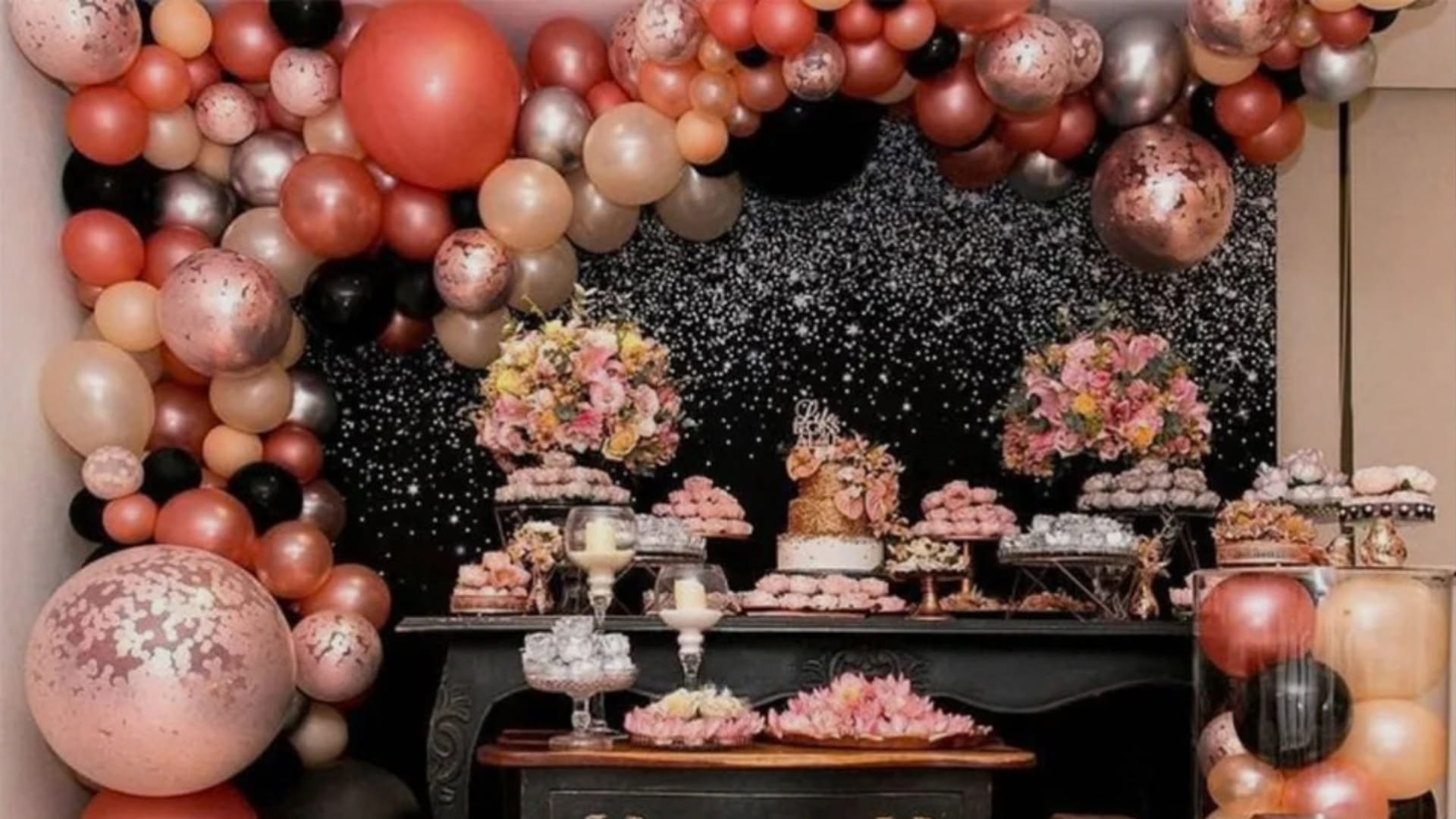 Dessert table with flowers, balloons and lighted 40 marquee numbers