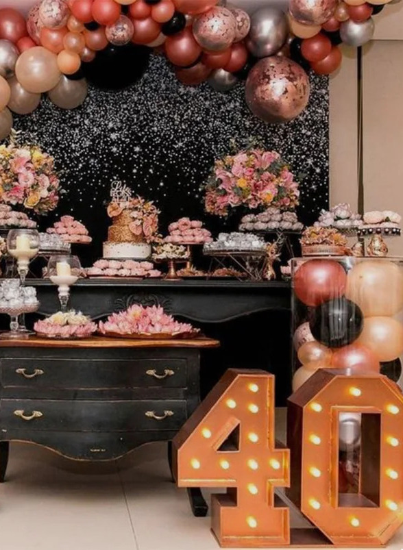 Dessert table with flowers, balloons and lighted "40" marquee numbers